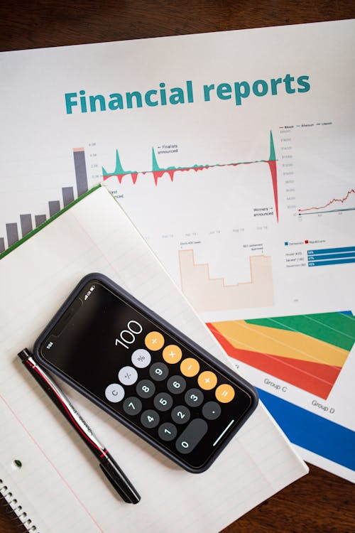 kenson Investments | Toward Standardized Reporting – Digital Asset Accounting Across Jurisdictions a document and calculator on the table