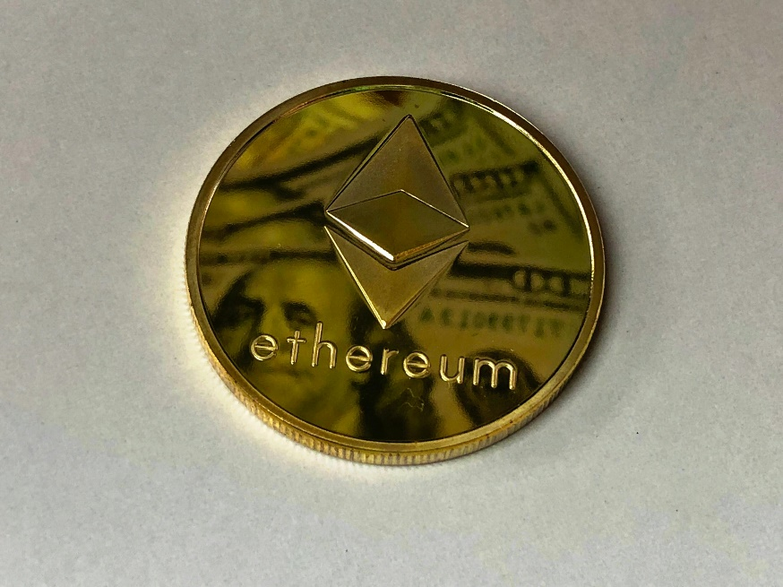kenson Investments | Banks Launch More Crypto Products Amid Regulatory Clarity Close-up of a gold-colored Ethereum ornament.