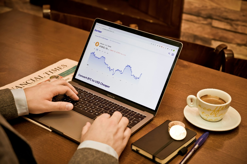 kenson Investments | The Growing Demand for Digital Asset Yield Strategies in a High-Rate Environment Professional analyzing digital asset yield strategies on a laptop