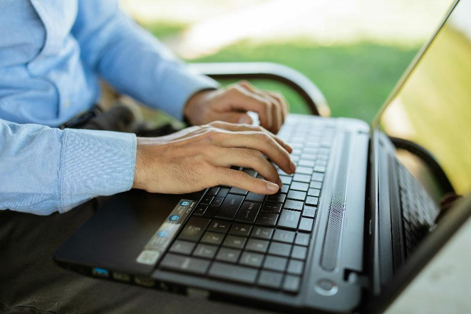 Technology consultant evaluating blockchain record-keeping applications on computer