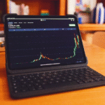 Laptop screen displaying digital asset trading dashboard for decentralized market analysis
