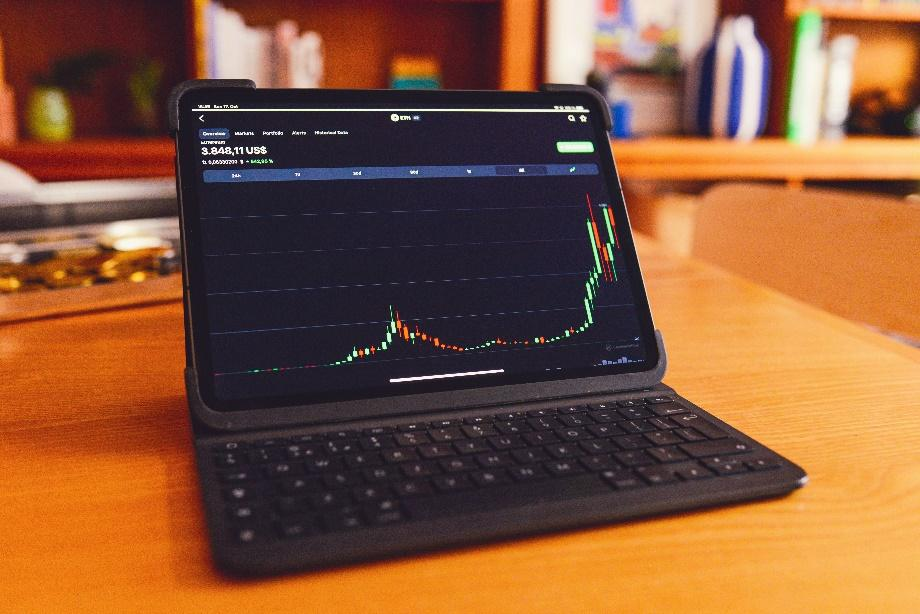 Laptop screen displaying digital asset trading dashboard for decentralized market analysis