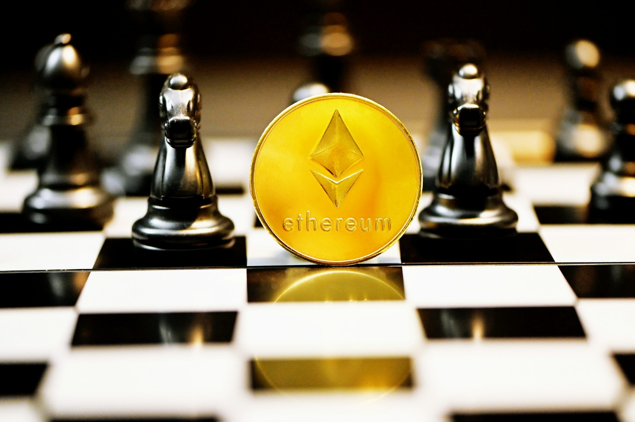 kenson Investments | ETH Surges Past $2,800: What’s Fueling the 2025 Ethereum Comeback? Ethereum coin standing on a chessboard with black chess pieces in the background