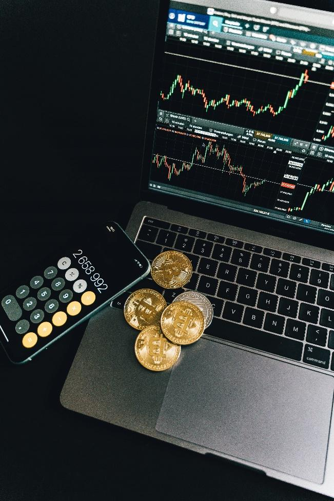 Gold coins placed on a laptop symbolizing digital asset storage