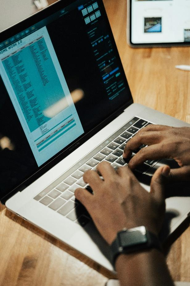 Digital asset specialist analyzing blockchain identity verification solutions on laptop