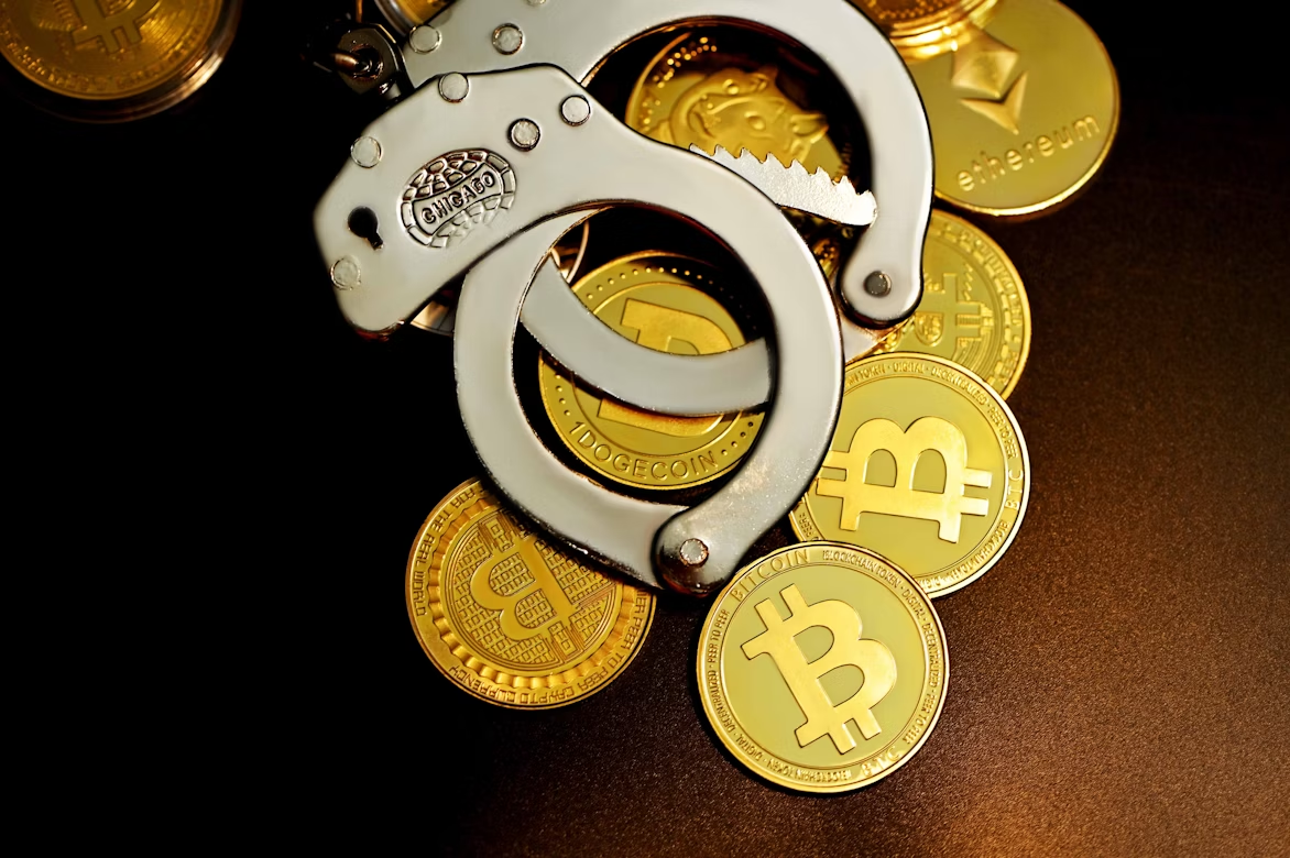 Cryptocurrency coins secured by handcuffs symbolizing the rise of crypto-related crime and security risks in digital assets.