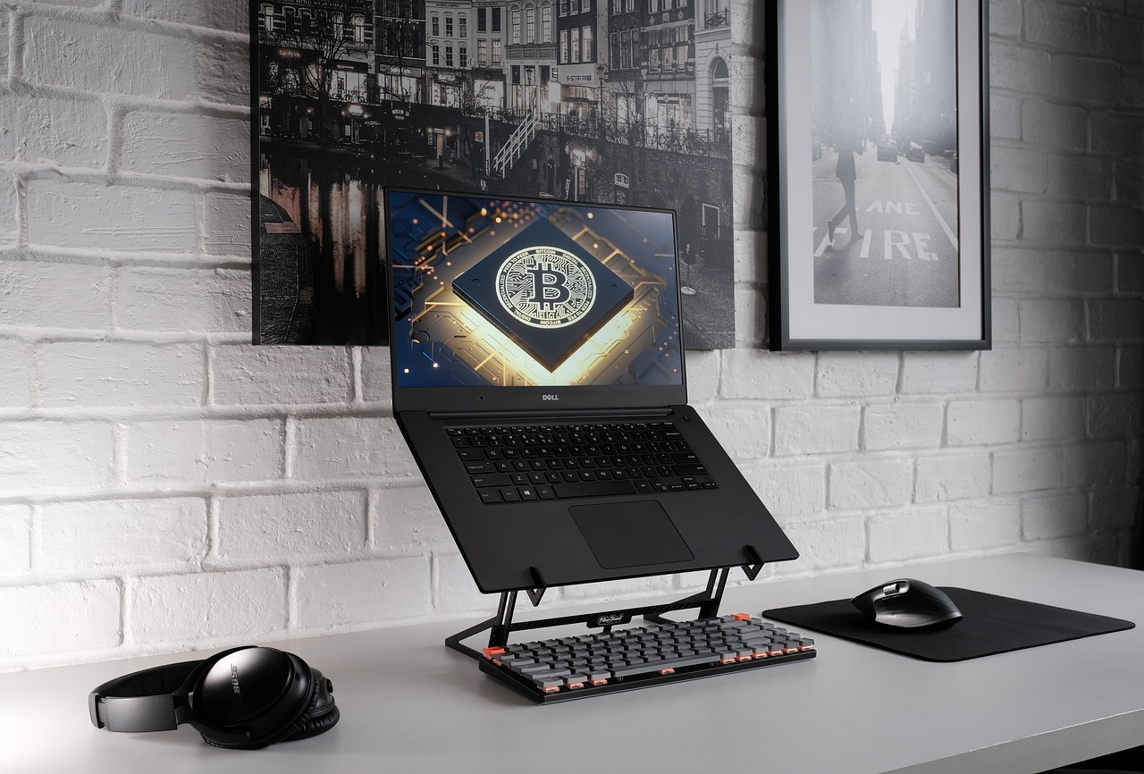 Laptop with Bitcoin symbol representing institutional use of blockchain timestamping for intellectual property protection and regulatory compliance.