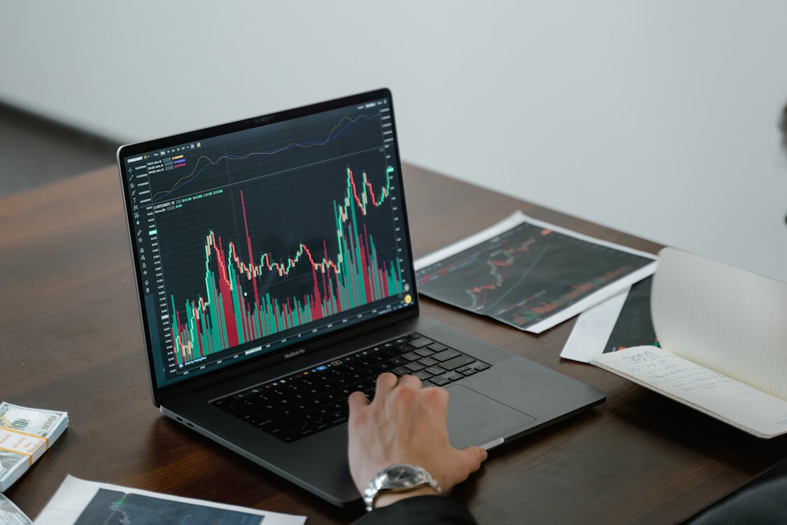 kenson Investments | Crypto Sentiment Moves to Fear as Appetite for Smaller Altcoins Dwindles Digital asset consultant analyzing altcoin charts and market trends on a laptop