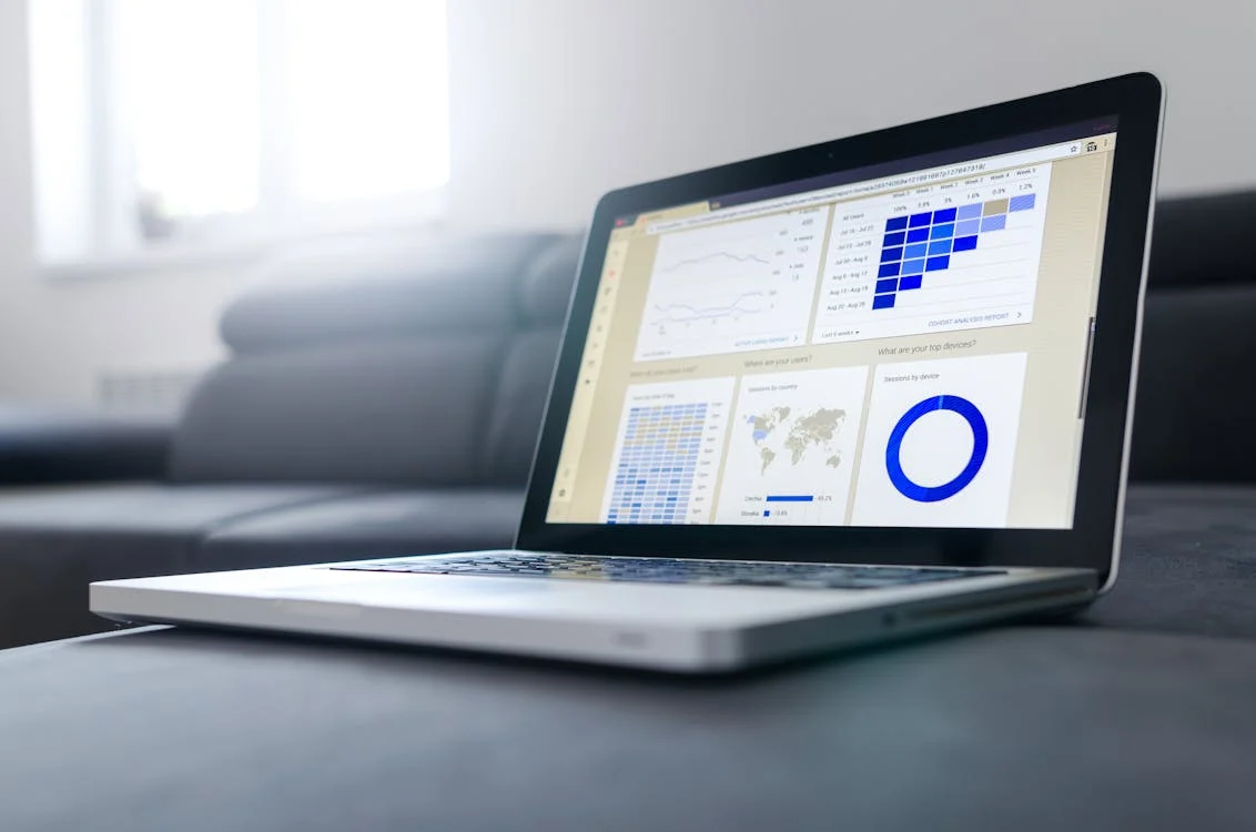 laptop with data visualizations on screen