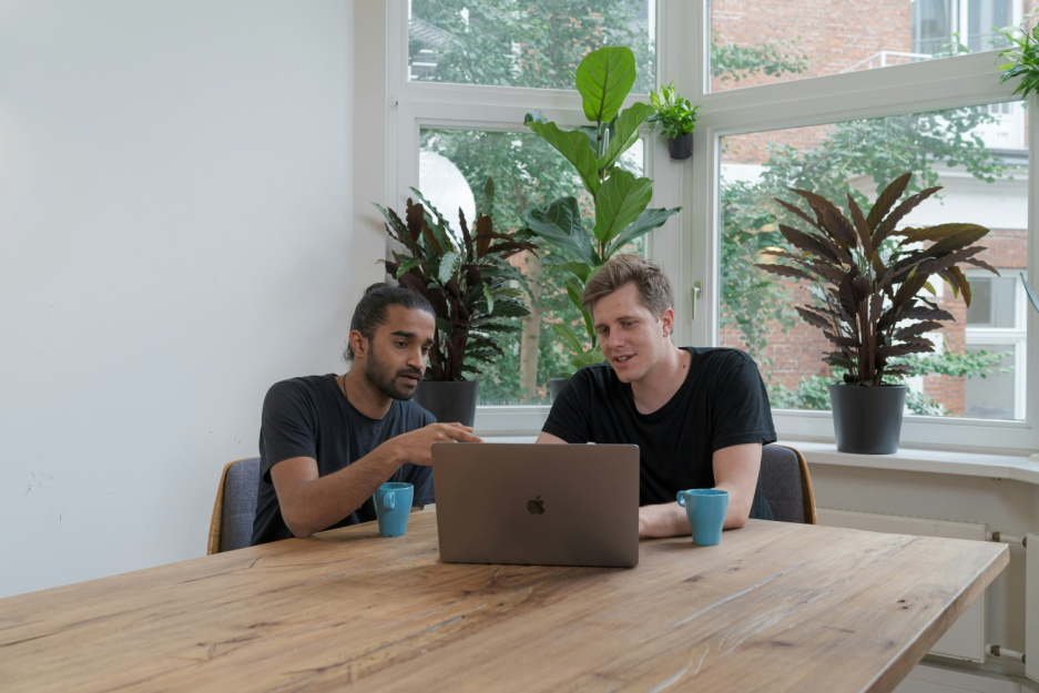 Two professionals reviewing financial data together at a table.