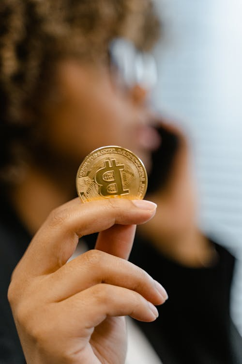A person holding a bitcoin.