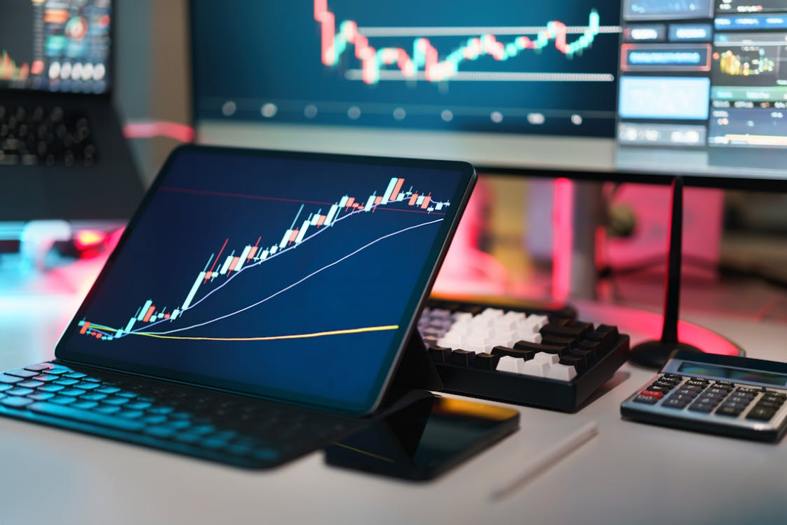 A modern trading desk displaying multiple screens with cryptocurrency charts, devices, and tools, representing digital asset management and operational monitoring.