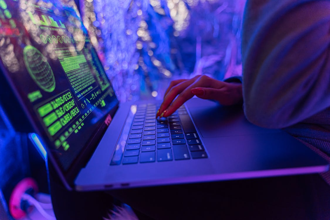 Person using a laptop to manage digital assets, illustrating operational tasks and security procedures in crypto asset management.