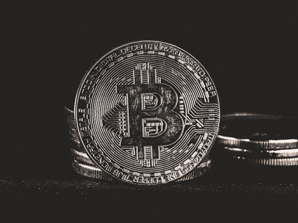 Round coins displayed on a dark surface, representing digital assets and cryptocurrency holdings.