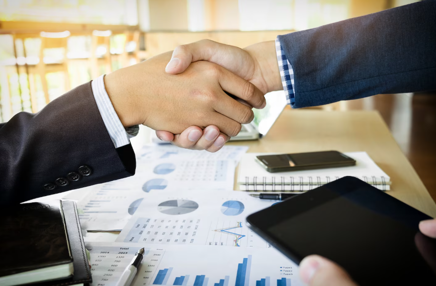 Digital asset specialists collaborating with clients in programmable finance, symbolized by a professional handshake.