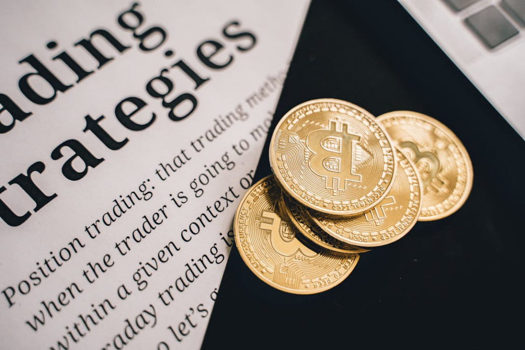 Gold round coins arranged on a white surface, representing digital assets and financial holdings.