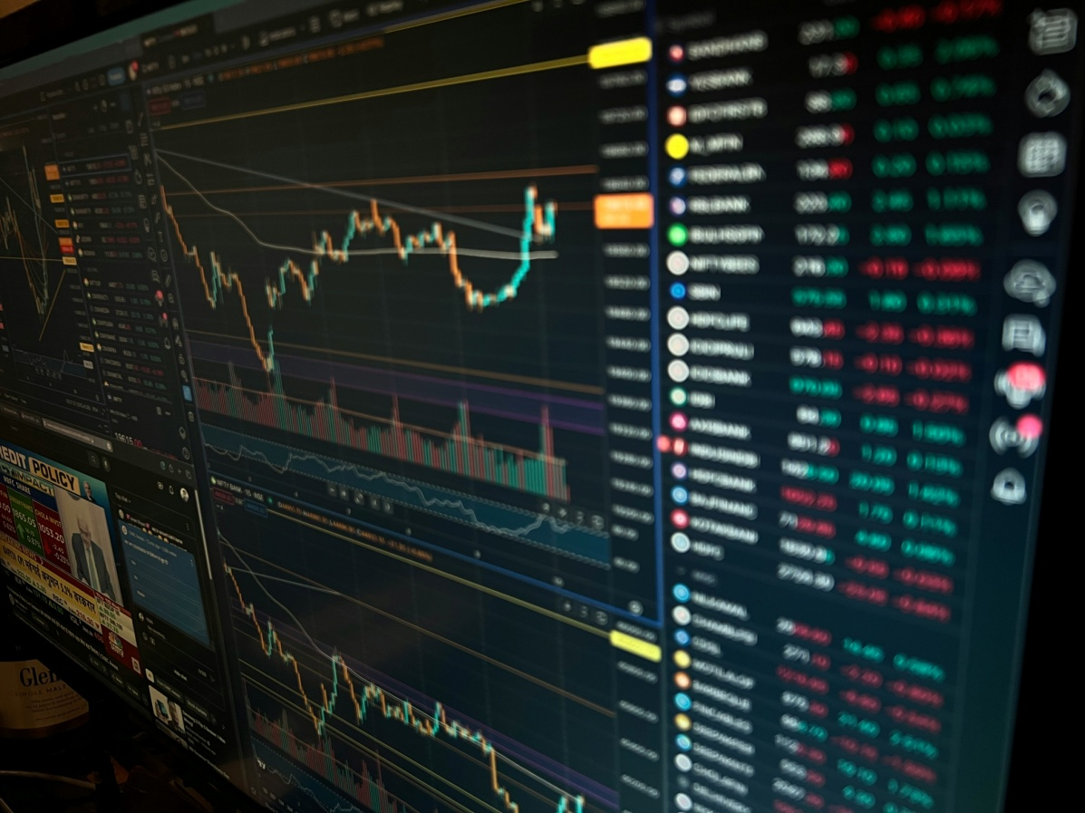 Multi-screen trading dashboard showing cryptocurrency price movements, order books, and market indicators across multiple digital assets.