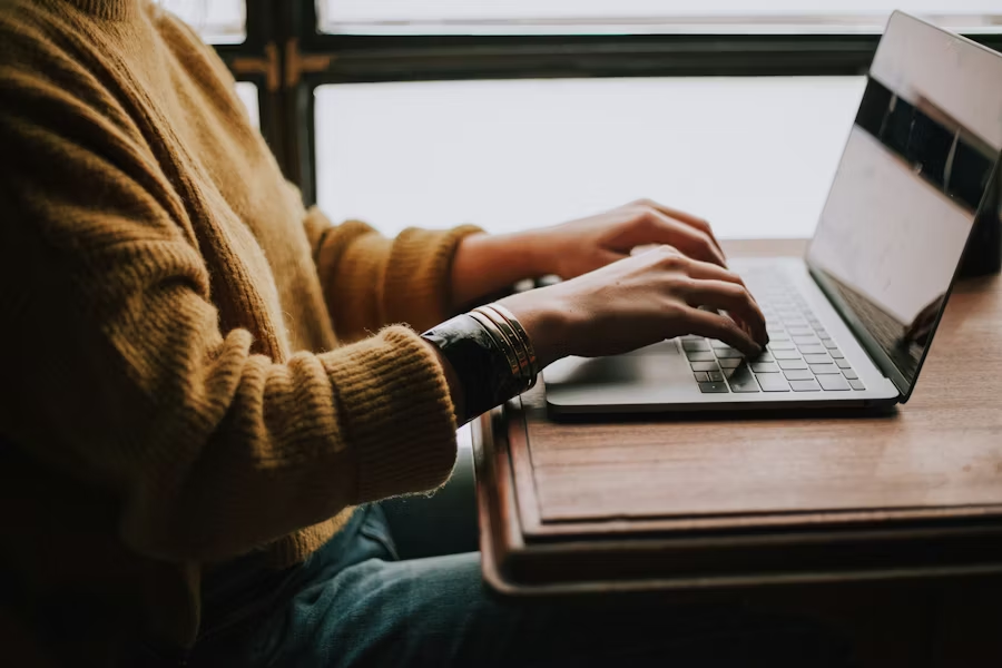 Person working on a laptop monitoring real-time trading data and risk limits before executing on-chain transactions
