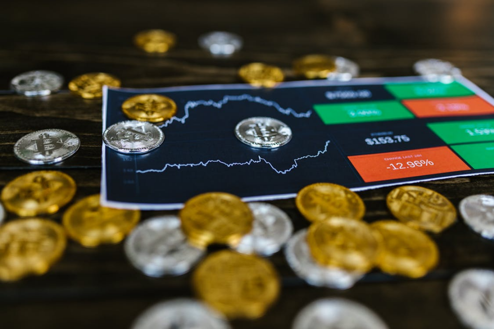 Silver and gold physical bitcoins placed together, representing diverse digital asset holdings.
