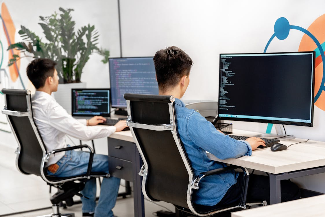 Developers reviewing smart contract code on multiple monitors