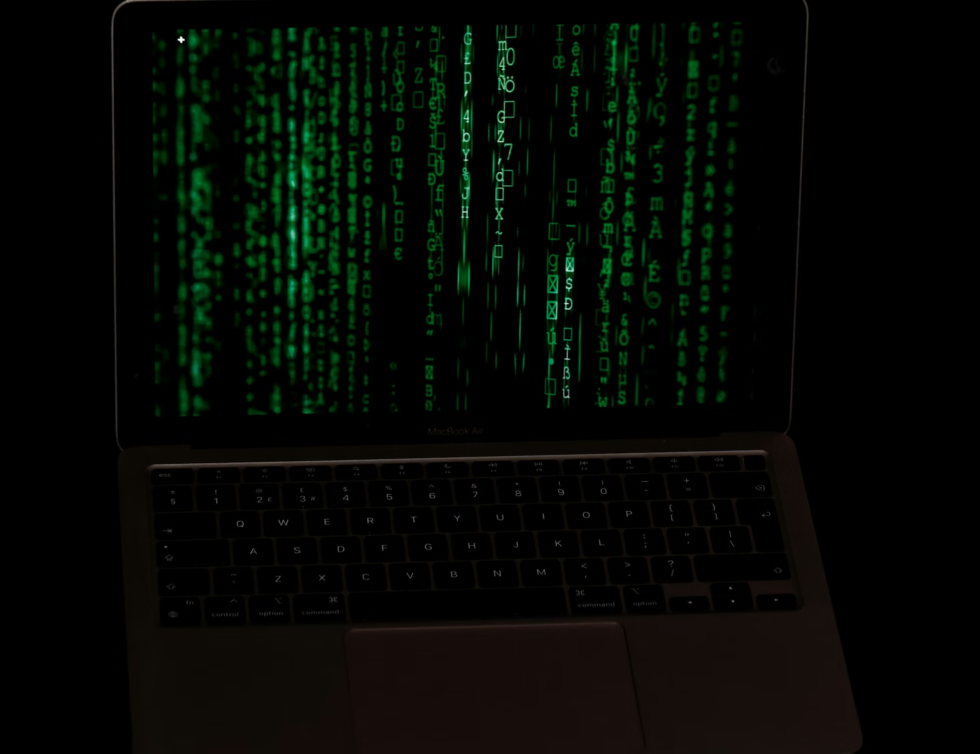 Laptop displaying green code illustrating vendor oversight and third-party infrastructure monitoring in digital asset systems