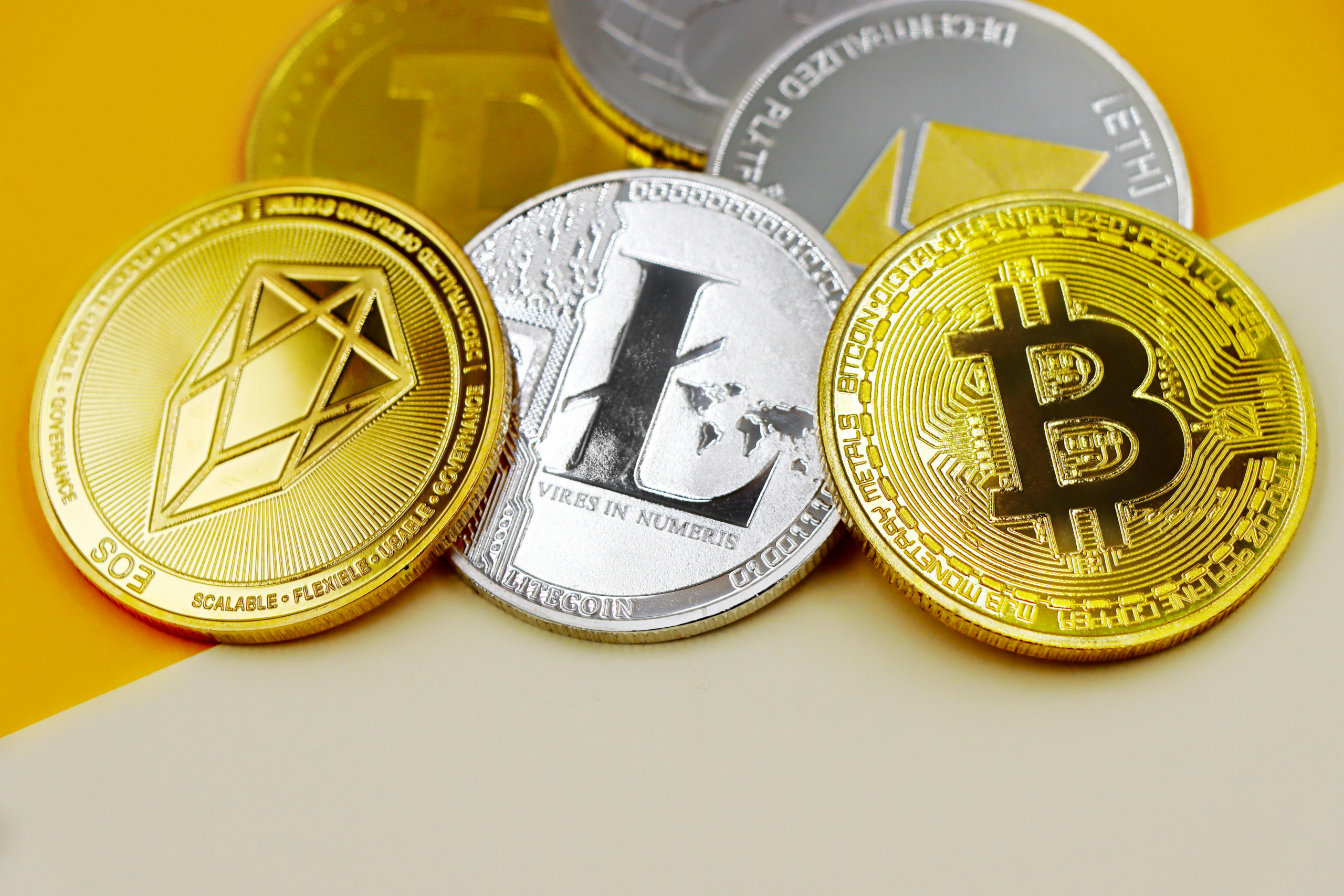close-up of bitcoin litecoin and eos coins.