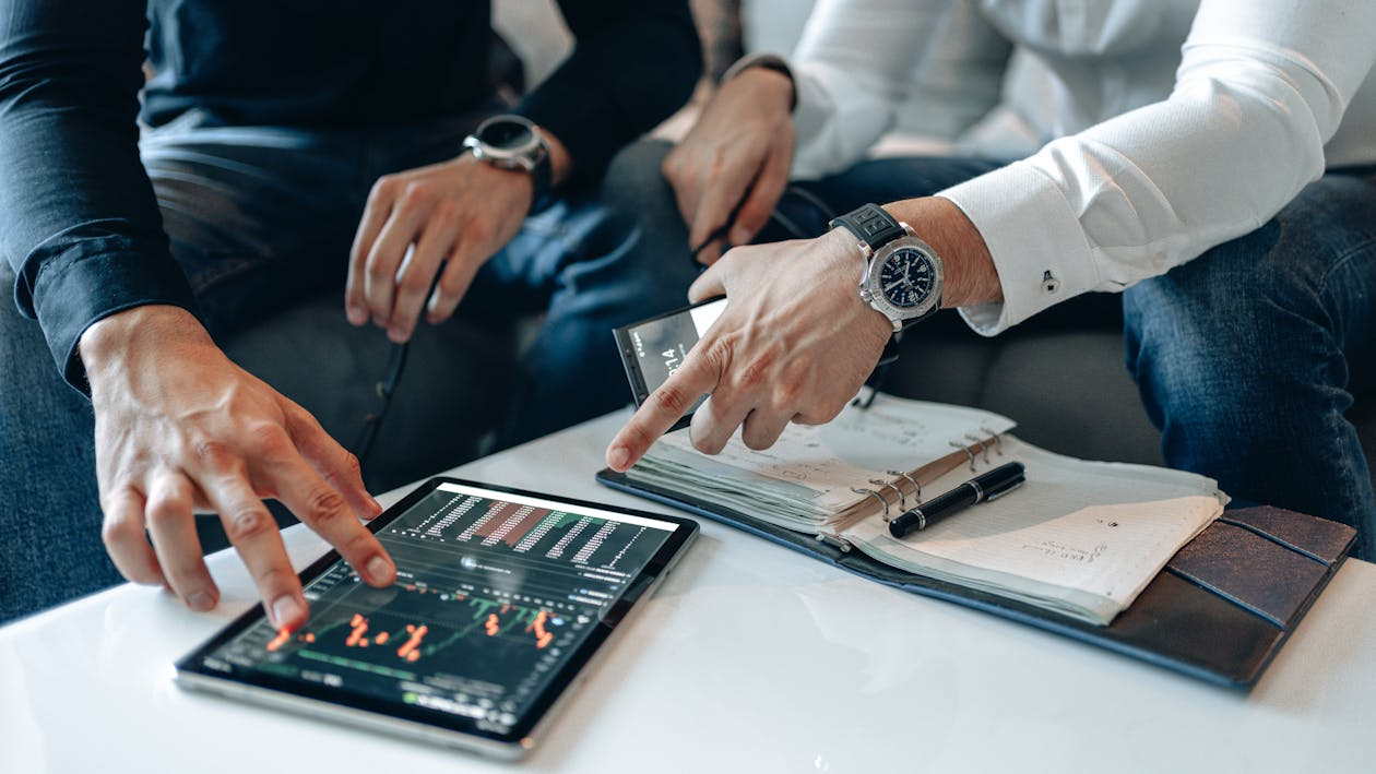 Analysts reviewing multiple data dashboards showing volatility, liquidity, and blockchain metrics
