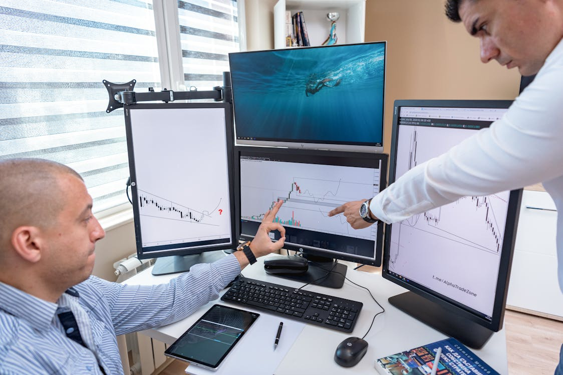 Professionals analyzing digital asset infrastructure data on multiple screens