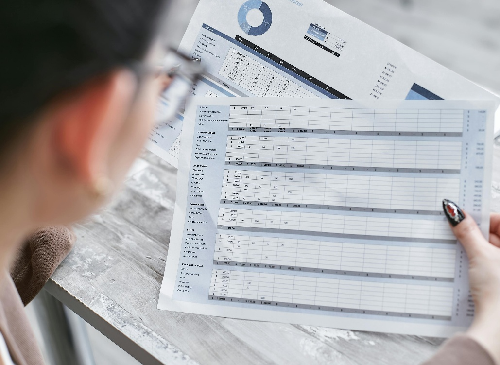 kenson Investments | Why Settlement Speed Alters Liquidity Behavior professional reviewing financial reports and charts during liquidity and risk analysis