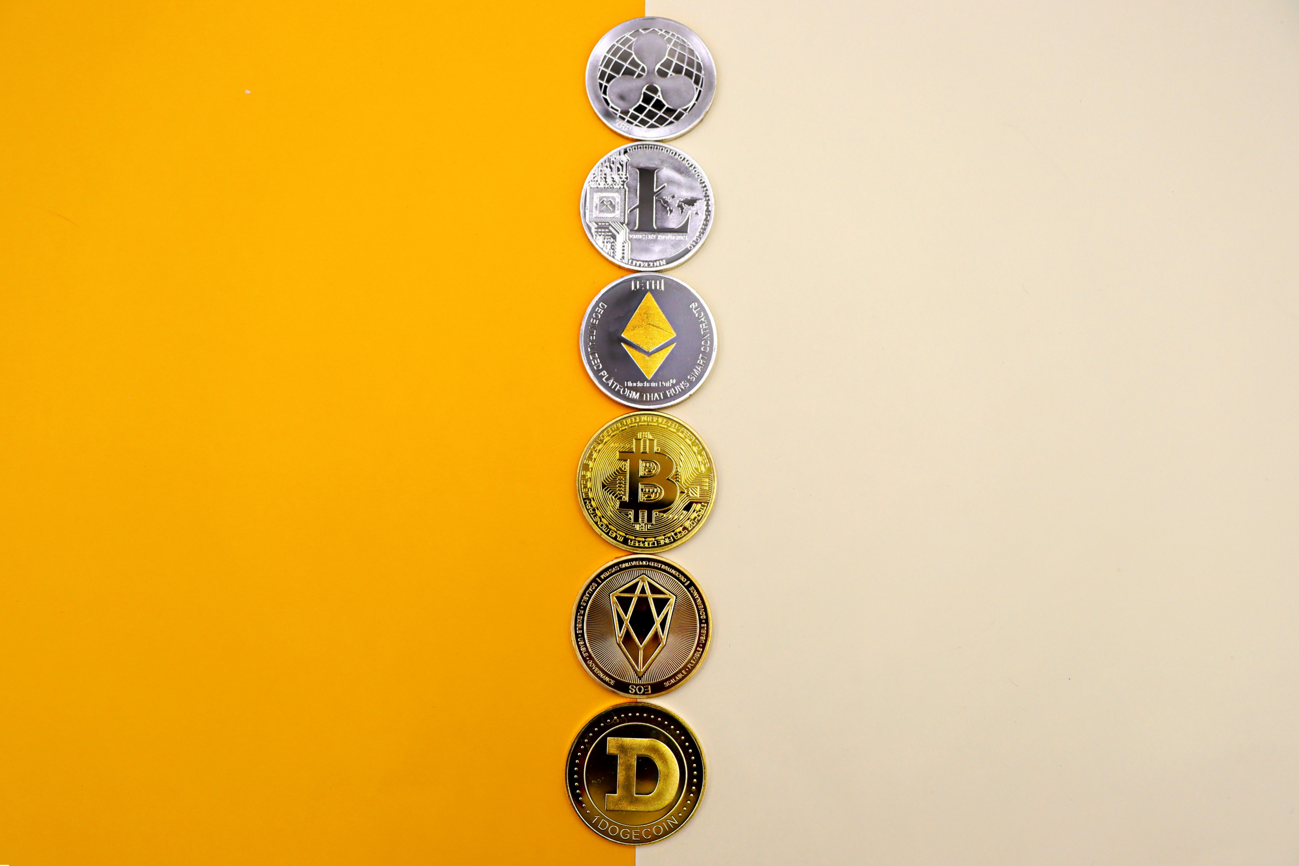 Cryptocurrency tokens arranged vertically on a yellow and white background