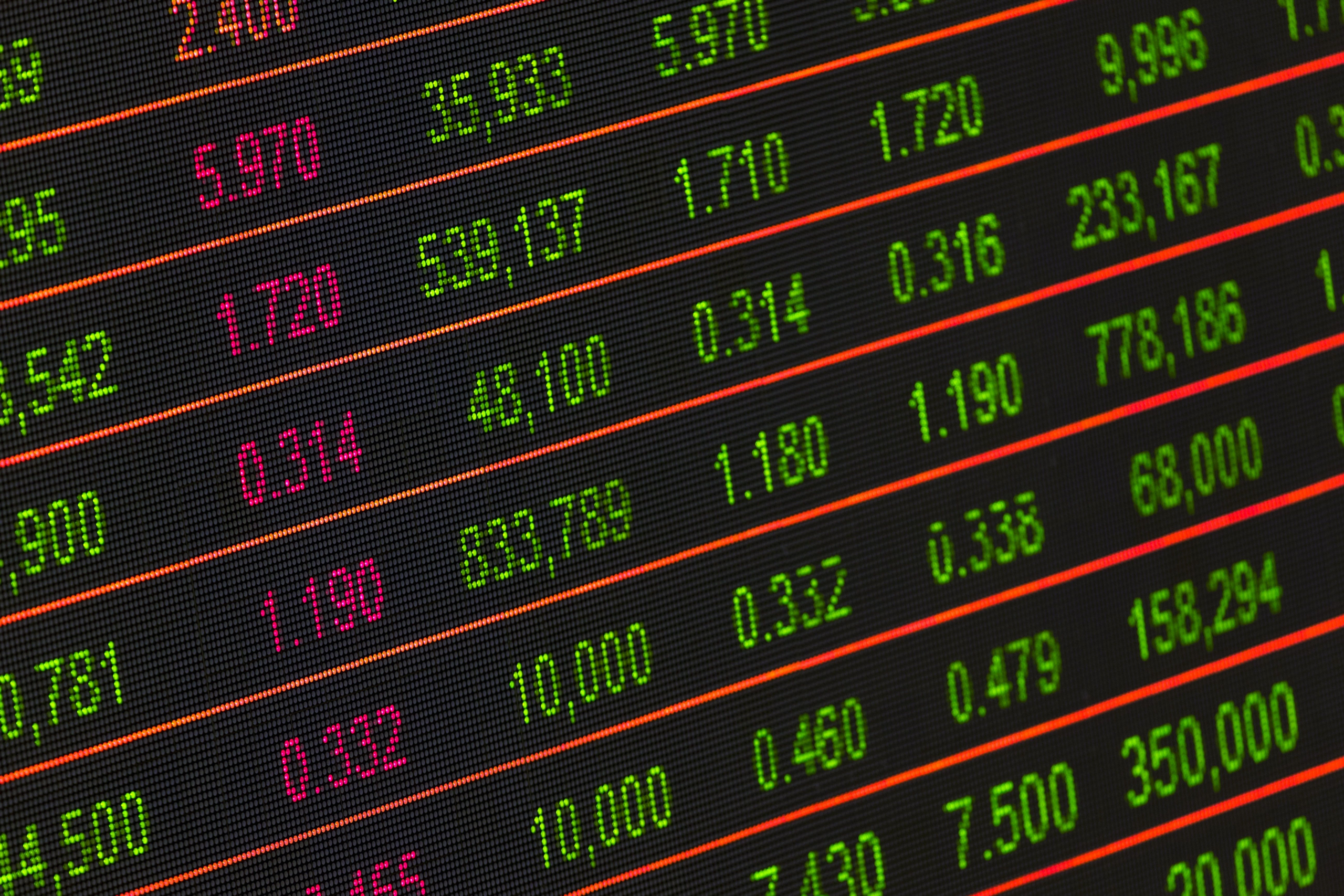 kenson Investments | Tokenized Securities Without the Wrapper: What DTCC’s Pilot Changes for Institutional Ownership Digital stock exchange board displaying securities market data