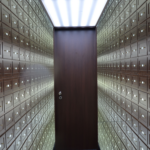 kenson Investments | When a Stablecoin Issuer Becomes a National Trust Bank Secure bank vault lined with individual deposit boxes