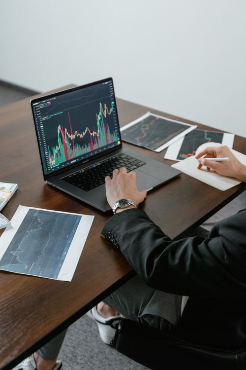 kenson Investments | Proactive Wallet Hardening: Managing UTXO Exposure Before the Quantum Era Close-up of a person typing on a laptop keyboard on a workspace table.