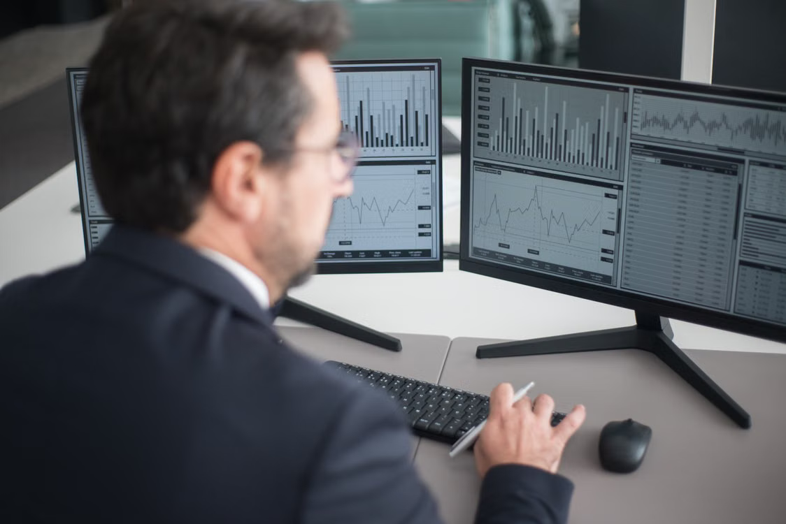 A finance professional reviewing ETF inflow and outflow data on a computer screen.