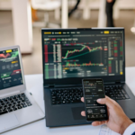A person reviewing digital currency charts and stablecoin data on a laptop screen.