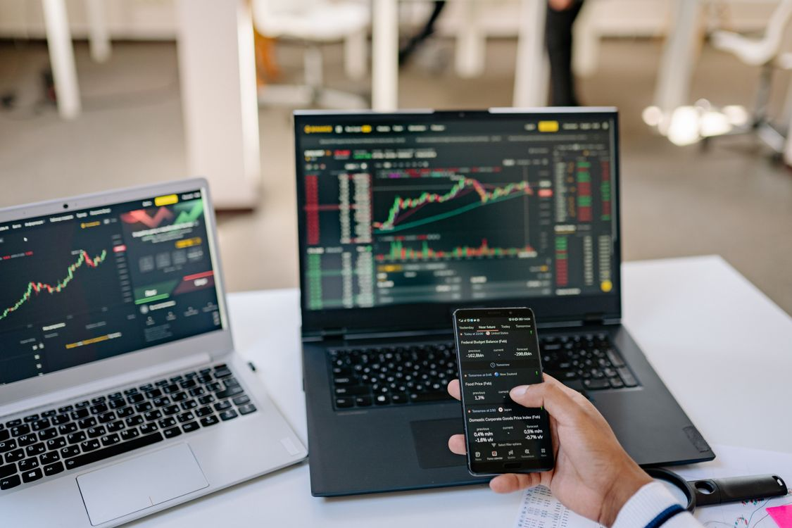 A person reviewing digital currency charts and stablecoin data on a laptop screen.