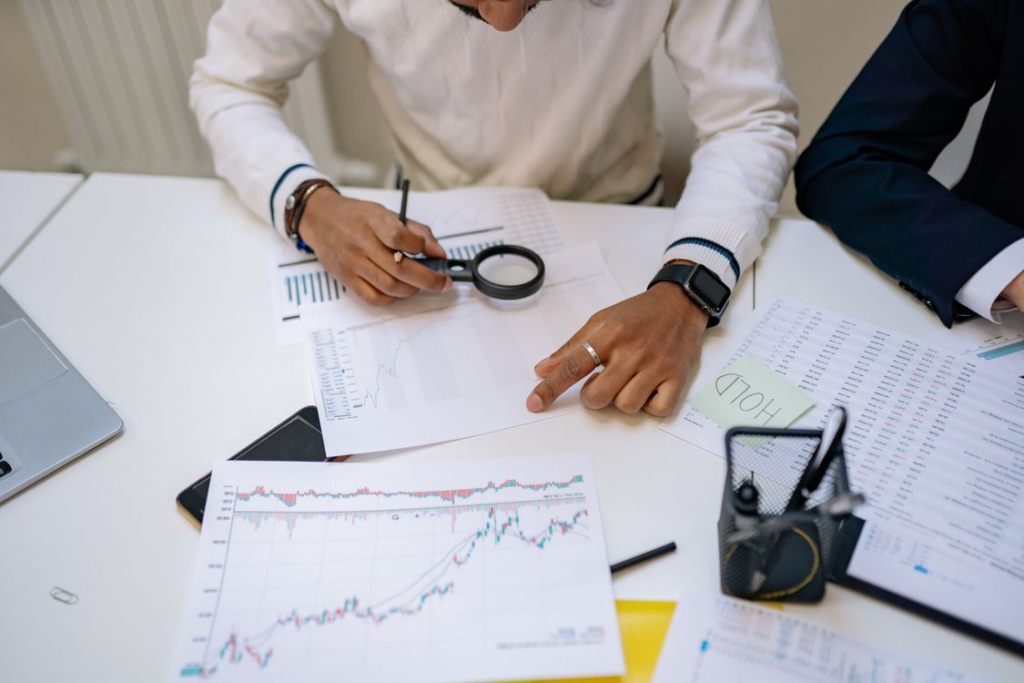 kenson Investments | Understanding the CLARITY Act: Why Digital Asset Regulation Matters A research analyst studying charts and legislative documents related to digital asset market structure.