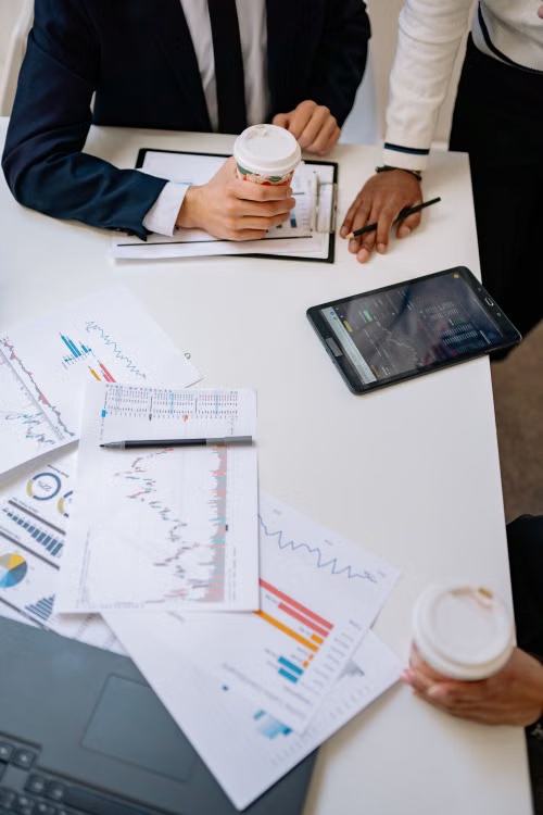 kenson Investments | Understanding the CLARITY Act: Why Digital Asset Regulation Matters A team reviewing digital asset market research and legislative updates in an office setting.