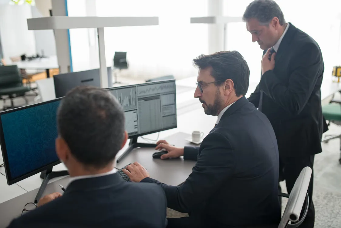 Operations team monitoring blockchain settlement activity through advanced financial technology systems.