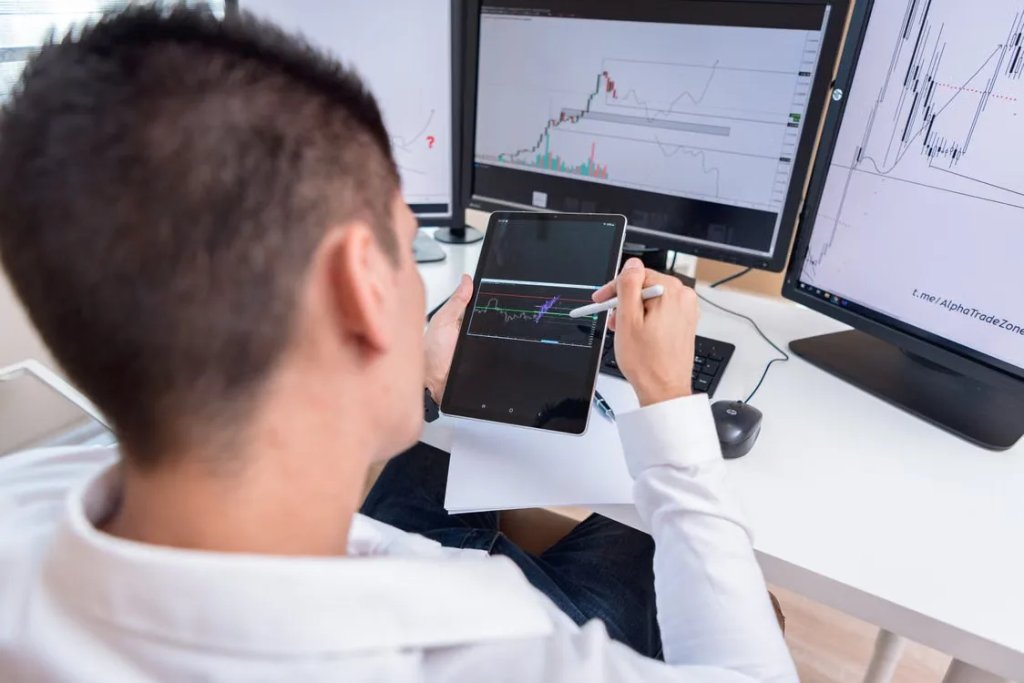 Analyst studying charts showing cryptocurrency market movements and institutional capital flows.