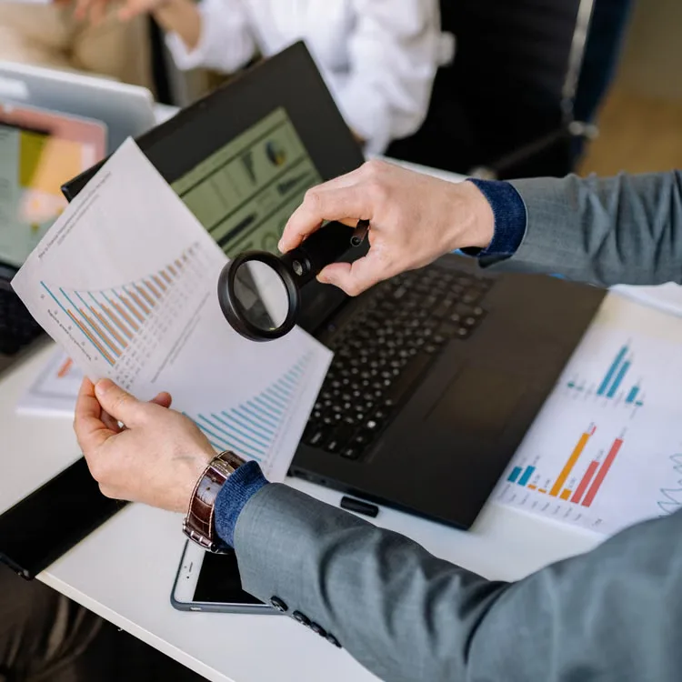 kenson Investments | Bitcoin's Resilience Despite Regulatory and Interest Rate Headwinds Research team examining market data and digital asset trends in a modern office environment.