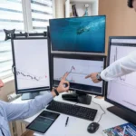 Financial professionals reviewing digital asset market data on multiple computer screens.