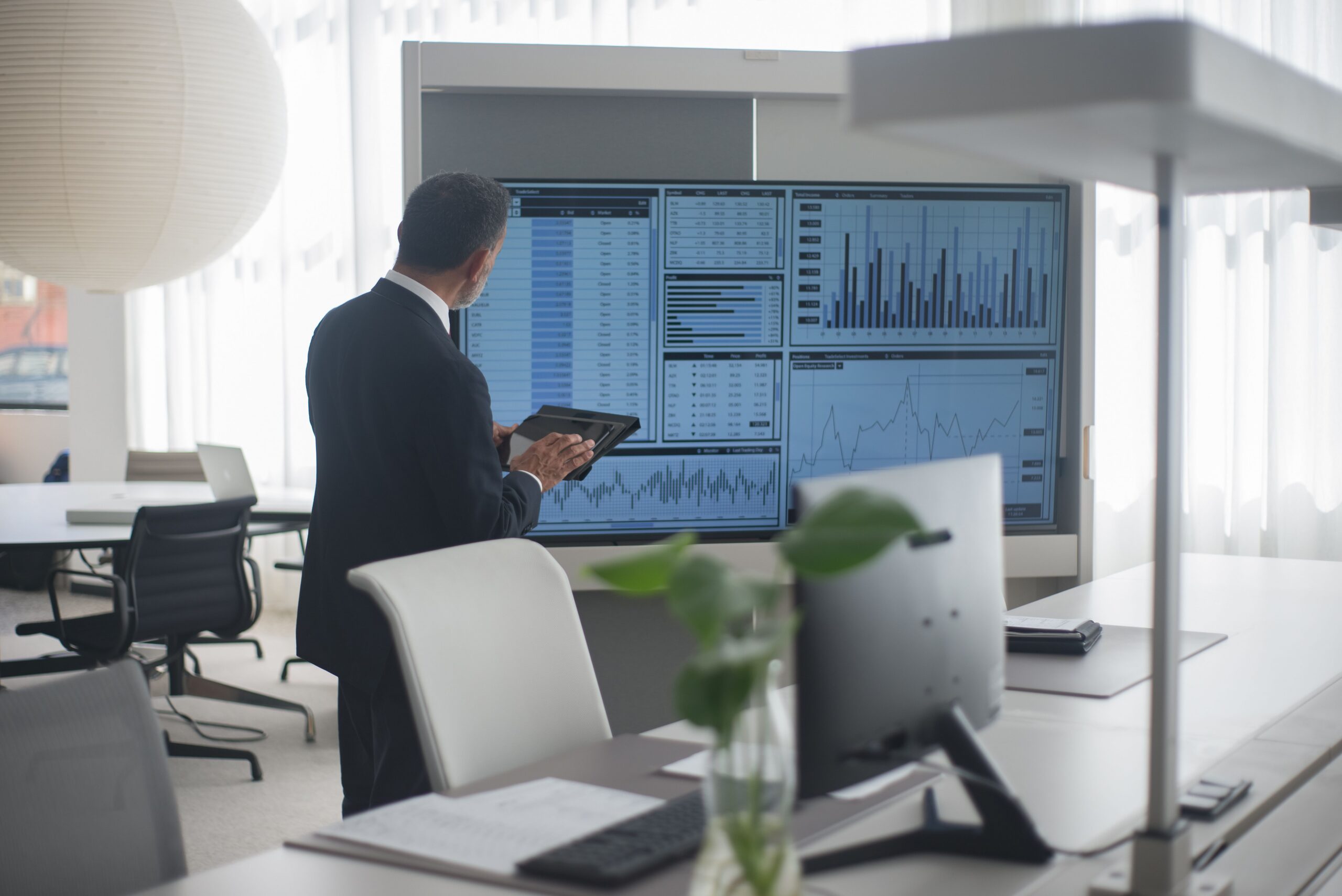 kenson Investments | Nasdaq’s $100 Million Payward Investment Deepens Its Tokenized Equities Push: Is the Exchange Model Converging With Crypto Infrastructure? Financial professional reviewing equity-market information on digital displays