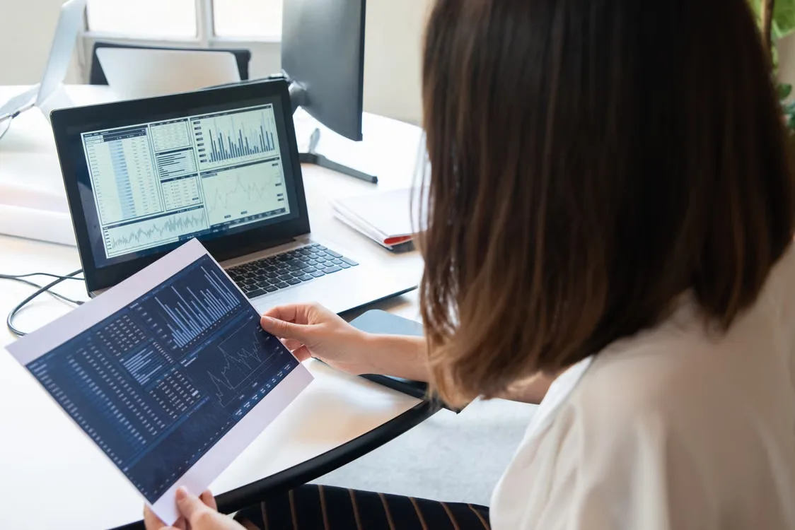 Person reviewing a digital ownership register and blockchain records.