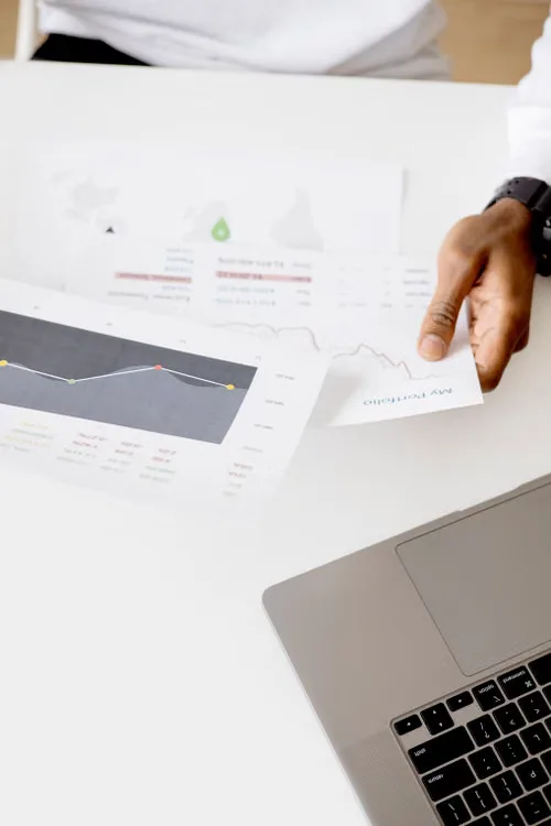 kenson Investments | Regulators Pursue Alternative Paths Following Legislative Delays Person reviewing digital asset regulatory information and market documents on a laptop.