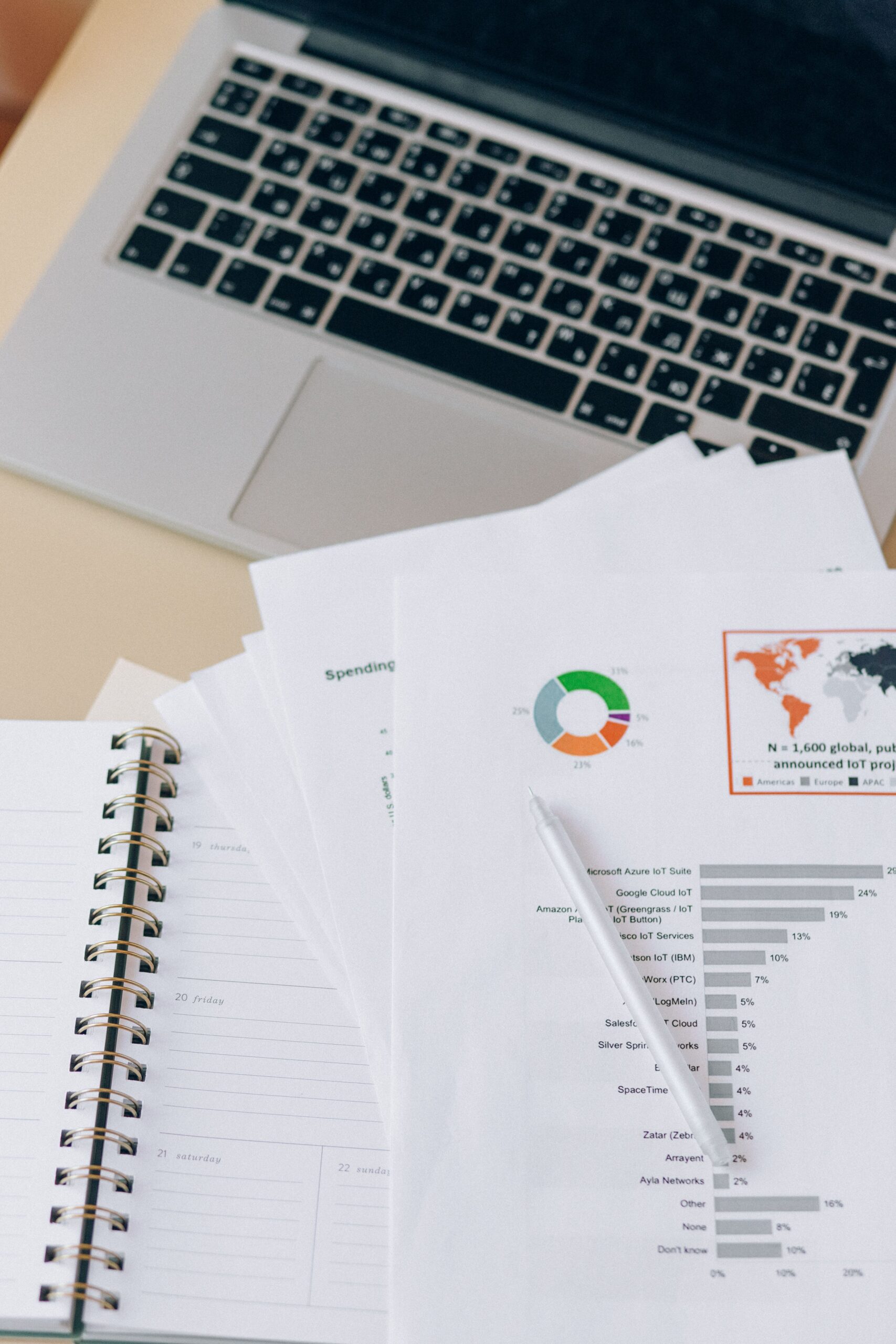 Financial documents beside a laptop representing regulated bond records, depository infrastructure, and ownership documentation