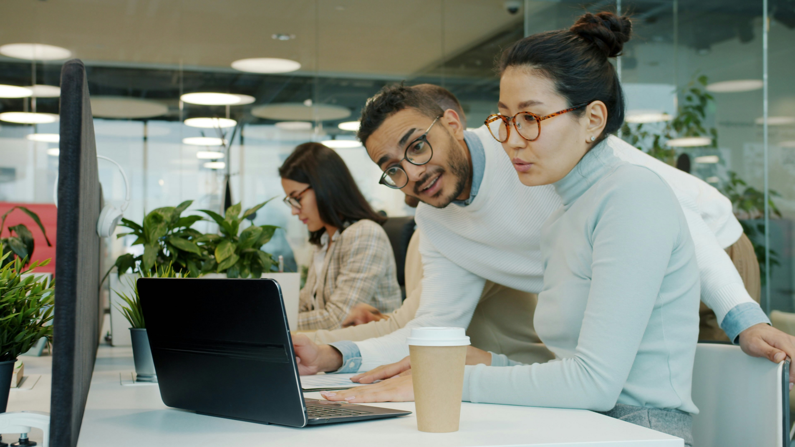 Business professional working on a laptop and documents in an office