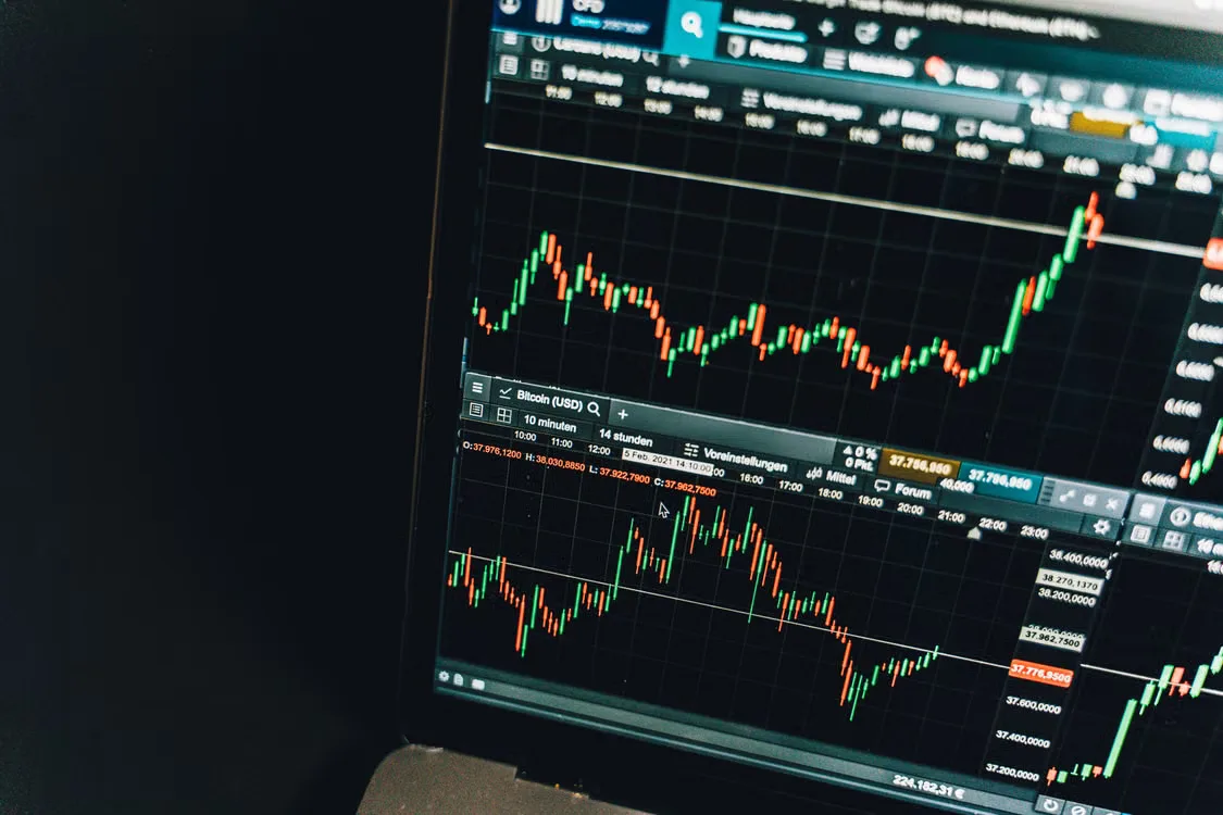 kenson Investments | Permissioned AMMs for Listed Equities: Pool Design and Market Constraints Close-up of a live cryptocurrency trading chart screen displaying dynamic market trends and analysis.