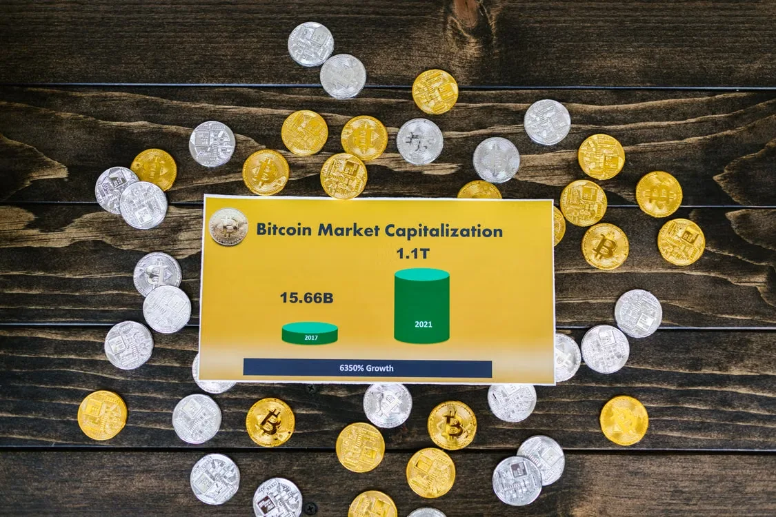 Bitcoin coins arranged on a wooden surface in a flat-lay composition.