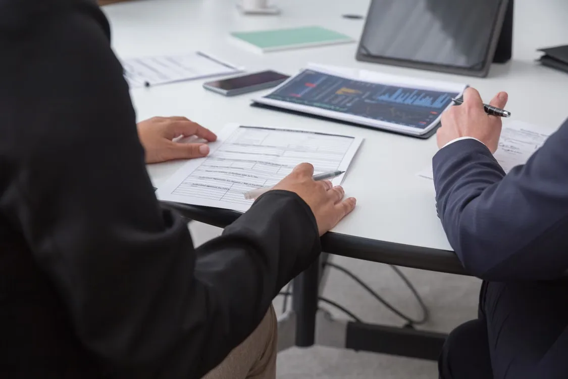 A business technology team reviewing the transition from a blockchain pilot environment to a live transaction processing system.